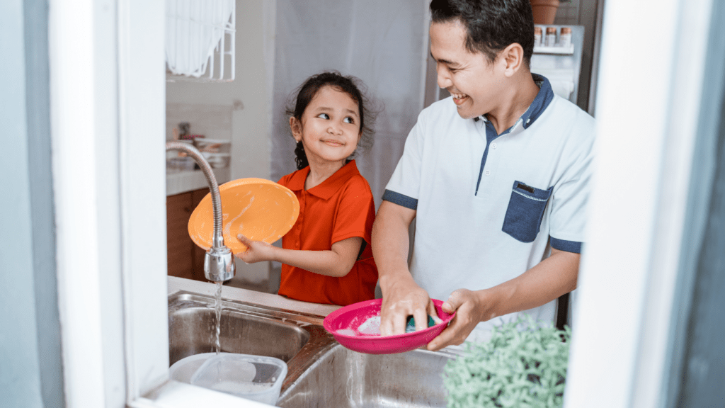 Father and Child washing Dishes 