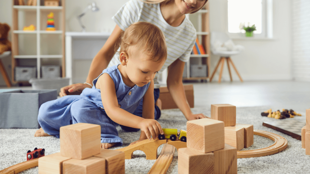 Toddler playing while the mother is supervising 