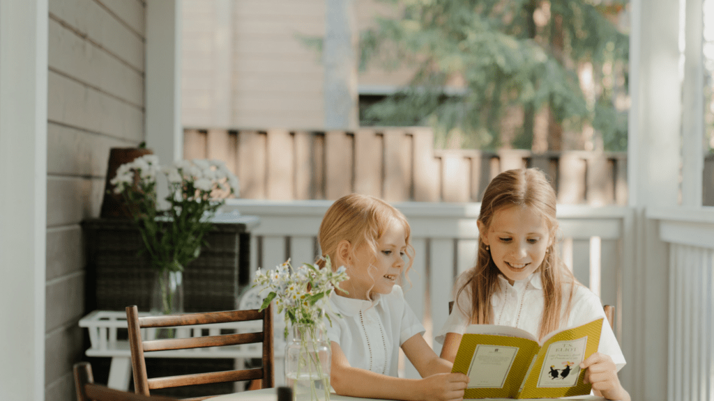 Siblings Reading A book
