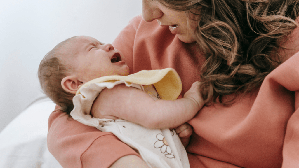 Mother holding her baby whos' crying