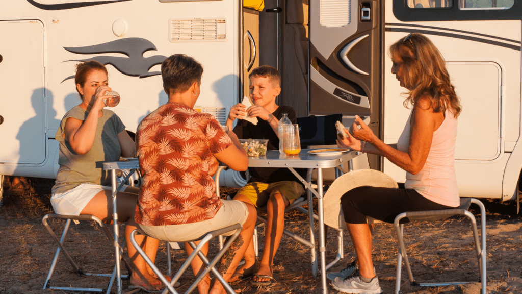 Family having breakfast out side RV